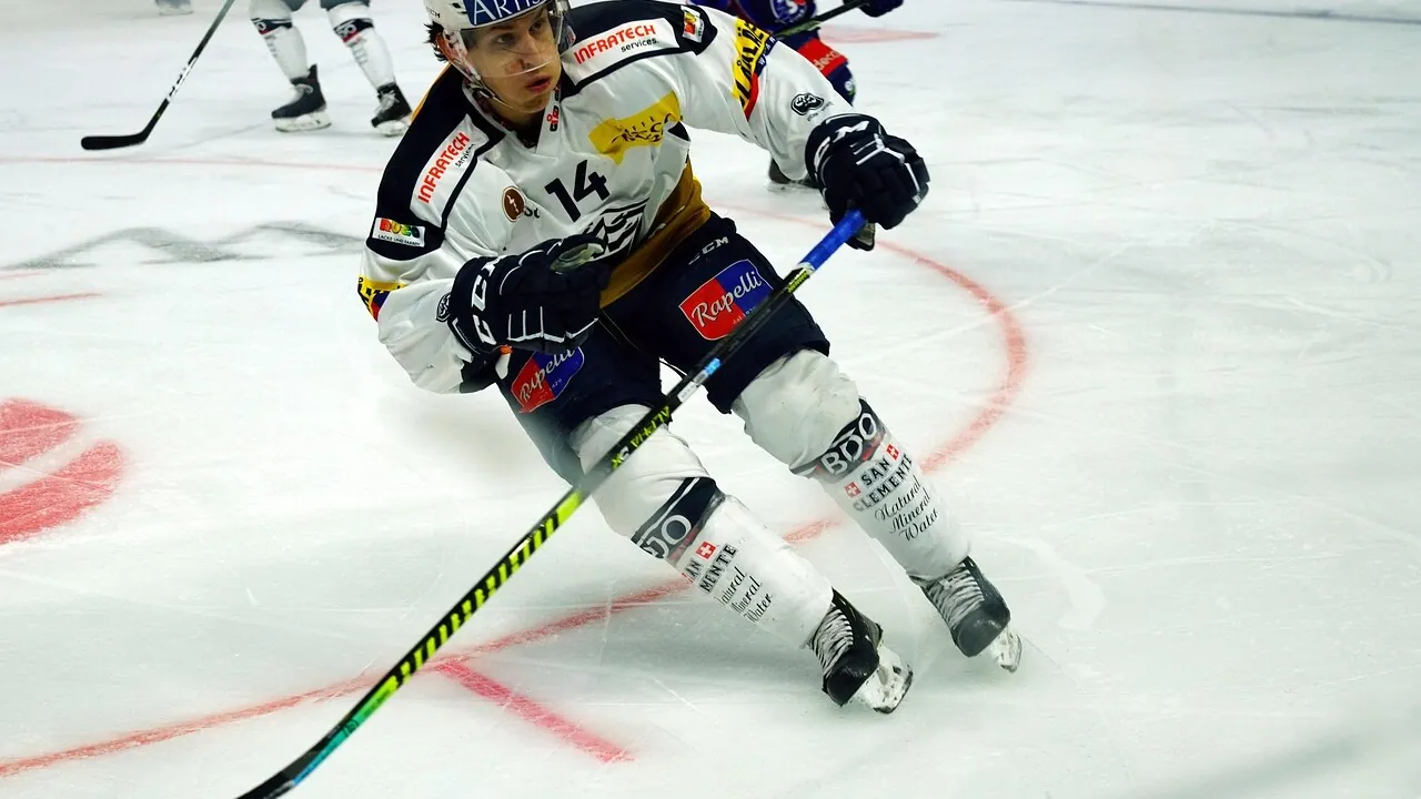 Ice hockey player skating with the puck during a professional game