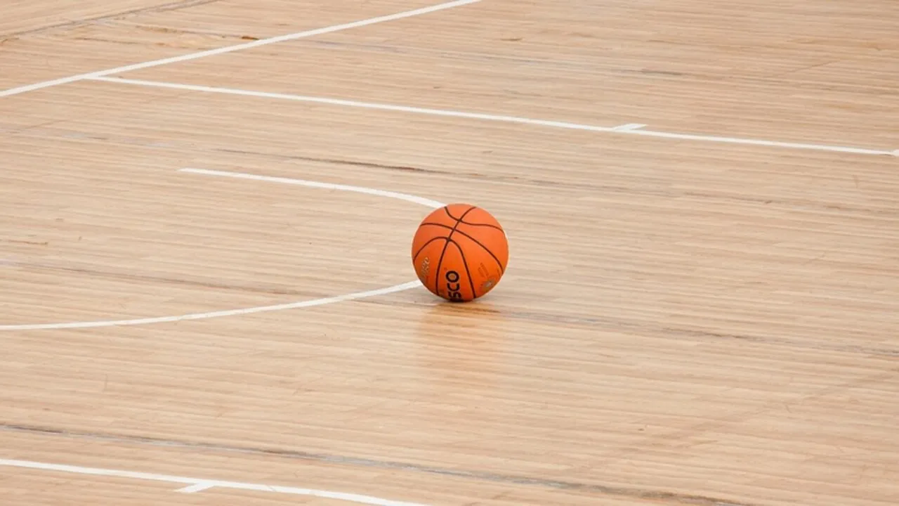 Basketball court inside an NBA-style arena viewed from courtside seats